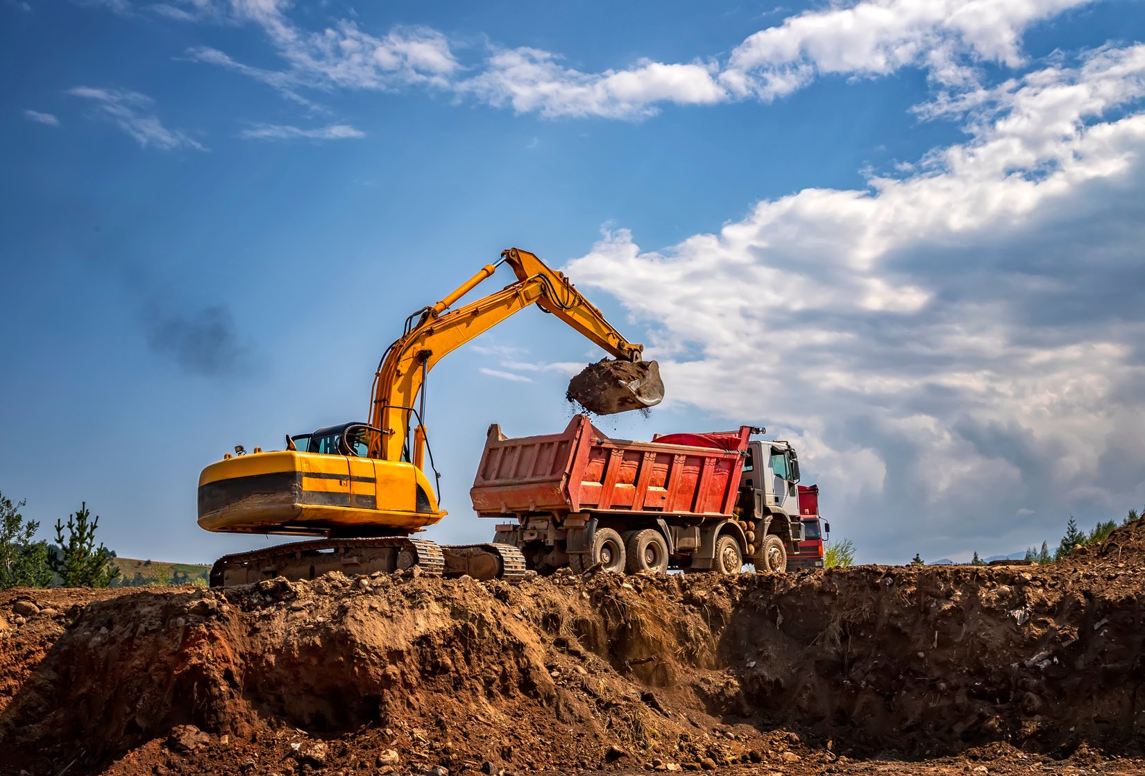 Excavator Putting Soil Into Dump Truck